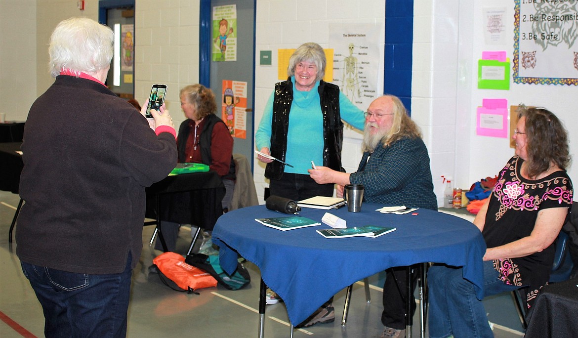 Local author, Parris ja Young, poses with the raffle winner who received his book of poems at the Senior Health Fair last weekend. (Kathleen Woodford/Mineral Independent).