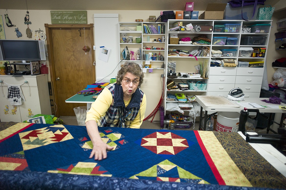 Peggy Aagenes-Janzer admires one of the quilts she&#146;s quilting for a customer.