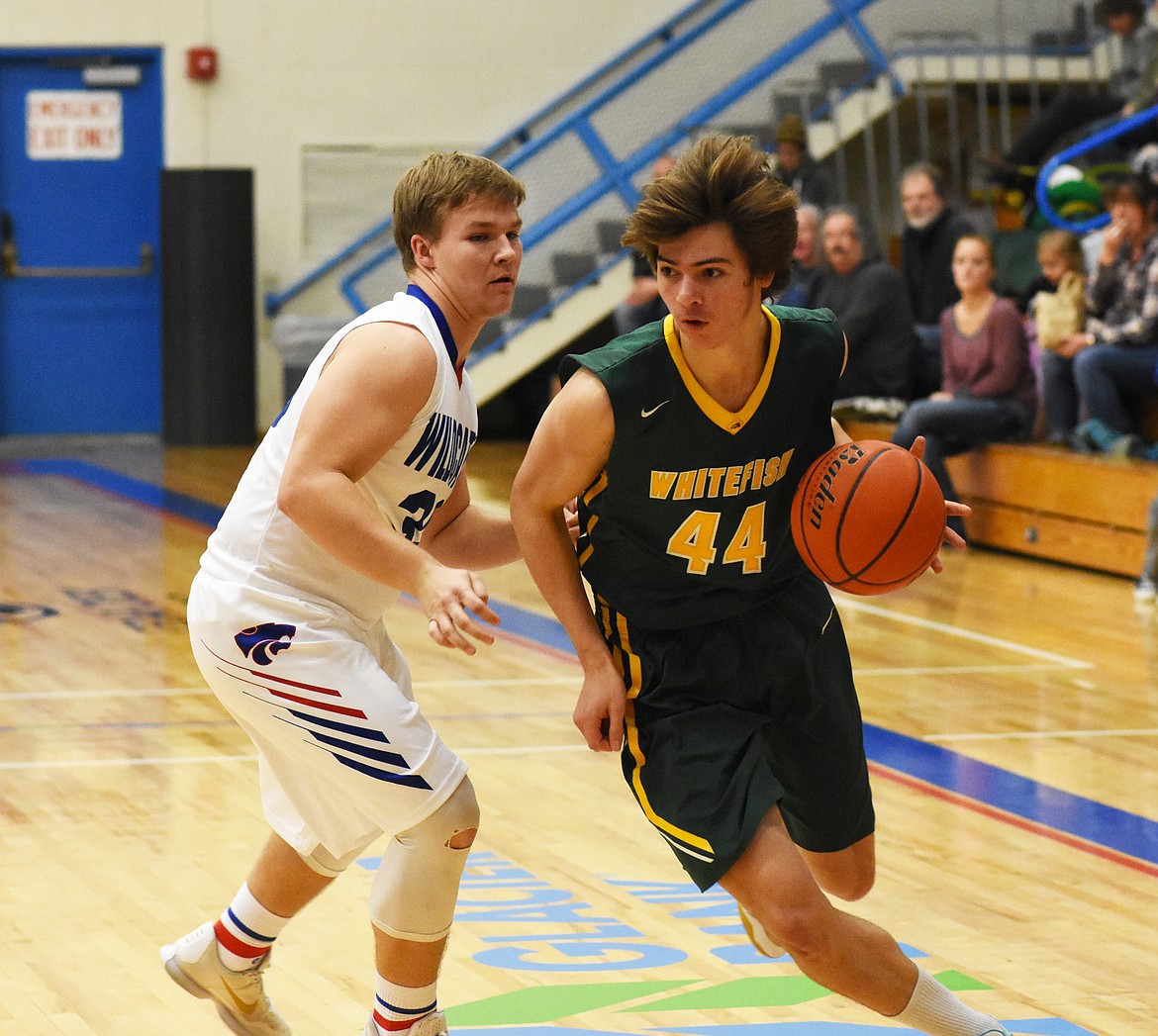 Lee Walburn gets by Columbia Falls&#146; Dakota Bridwell during Thursday night&#146;s win.