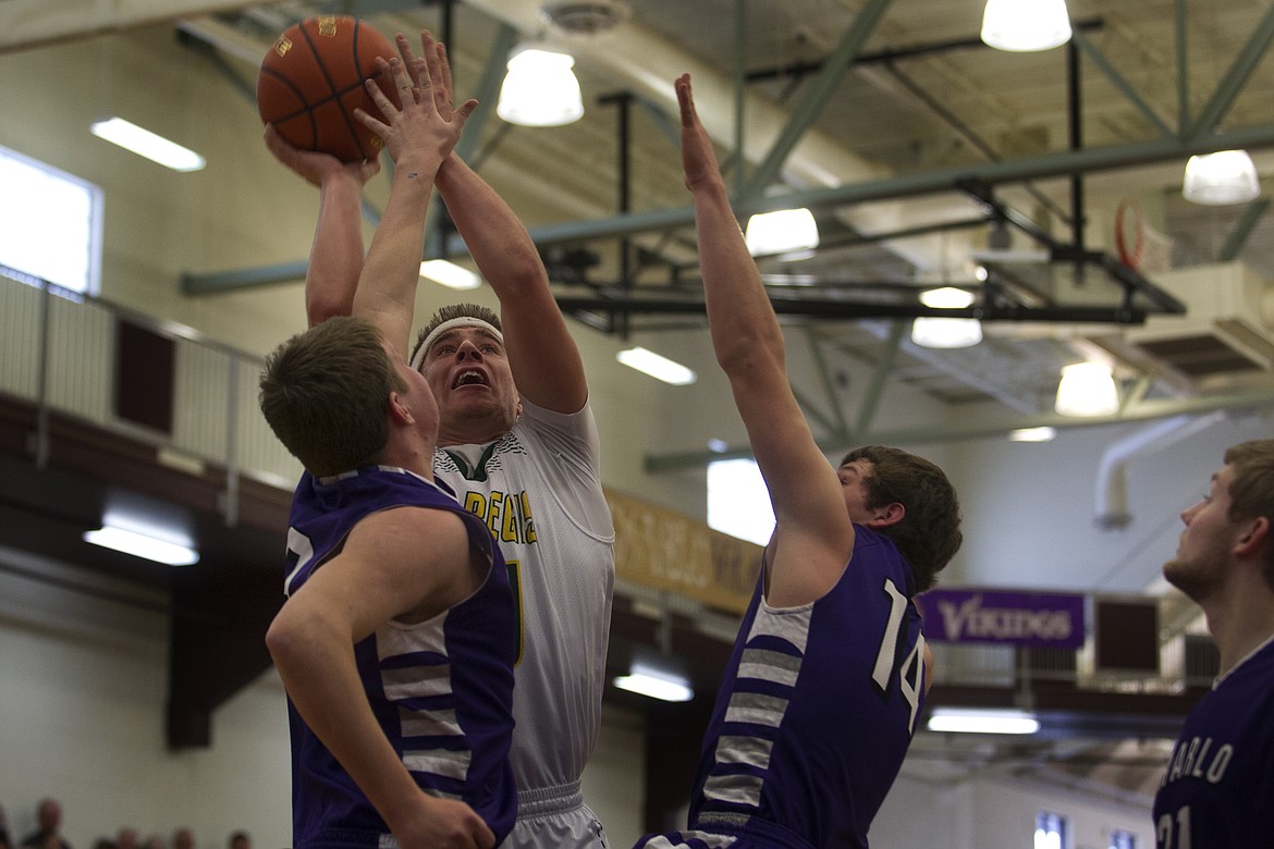 St. Regis forward Brock Cantrell-Field takes a jump shot over several Charlo defenders at the District 14C Tournament in Pablo Thursday. (Jeremy Weber/Lake County Leader)