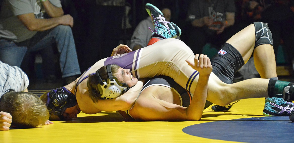 Photo by Amy Stepro
Wildcat Juddson Hall cranks on his opponenet&#146;s neck as he attempts to get the pin during the 113 pound championship match at districts.
