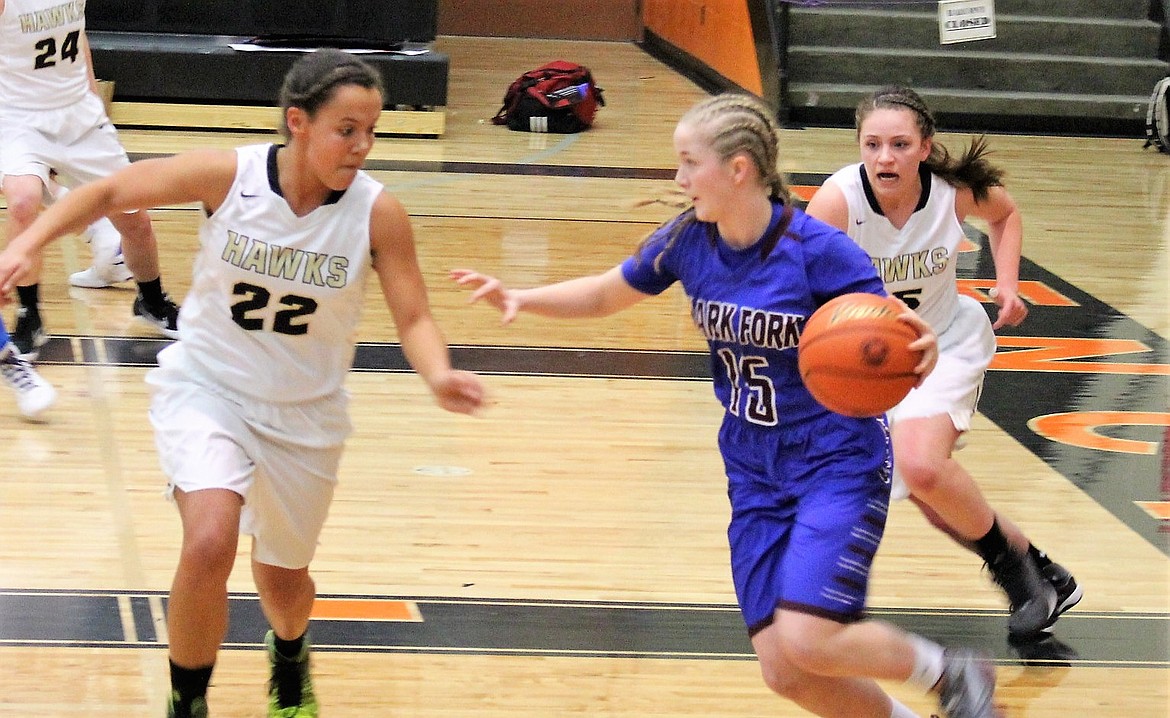 Lady Mountain Cat Hailey Kelly breaks away from Seeley-Swan players in the district championship game on Saturday. Cats lost 61-31. (Kathleen Woodford/Mineral Independent).