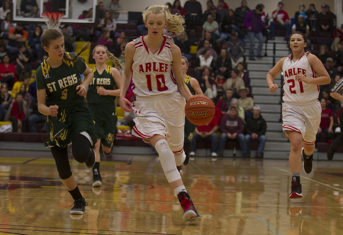 ARLEE&#146;S CARLY HERGETT (10) drives past St. Regis defender Madison Kelly (5) during action in the District 14C championship game in Pablo Saturday. Hergett scored eight as the Scarlets downed the Lady Tigers, 38-28. (Jeremy Weber/Lake County Leader)