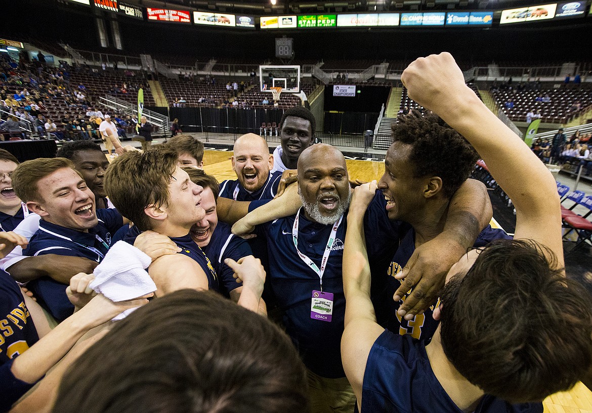 LOREN BENOIT/PressGenesis Prep players and Head Coach Marsell Colbert, center, celebrate at the center of the court after defeating Dietrich 68-62.