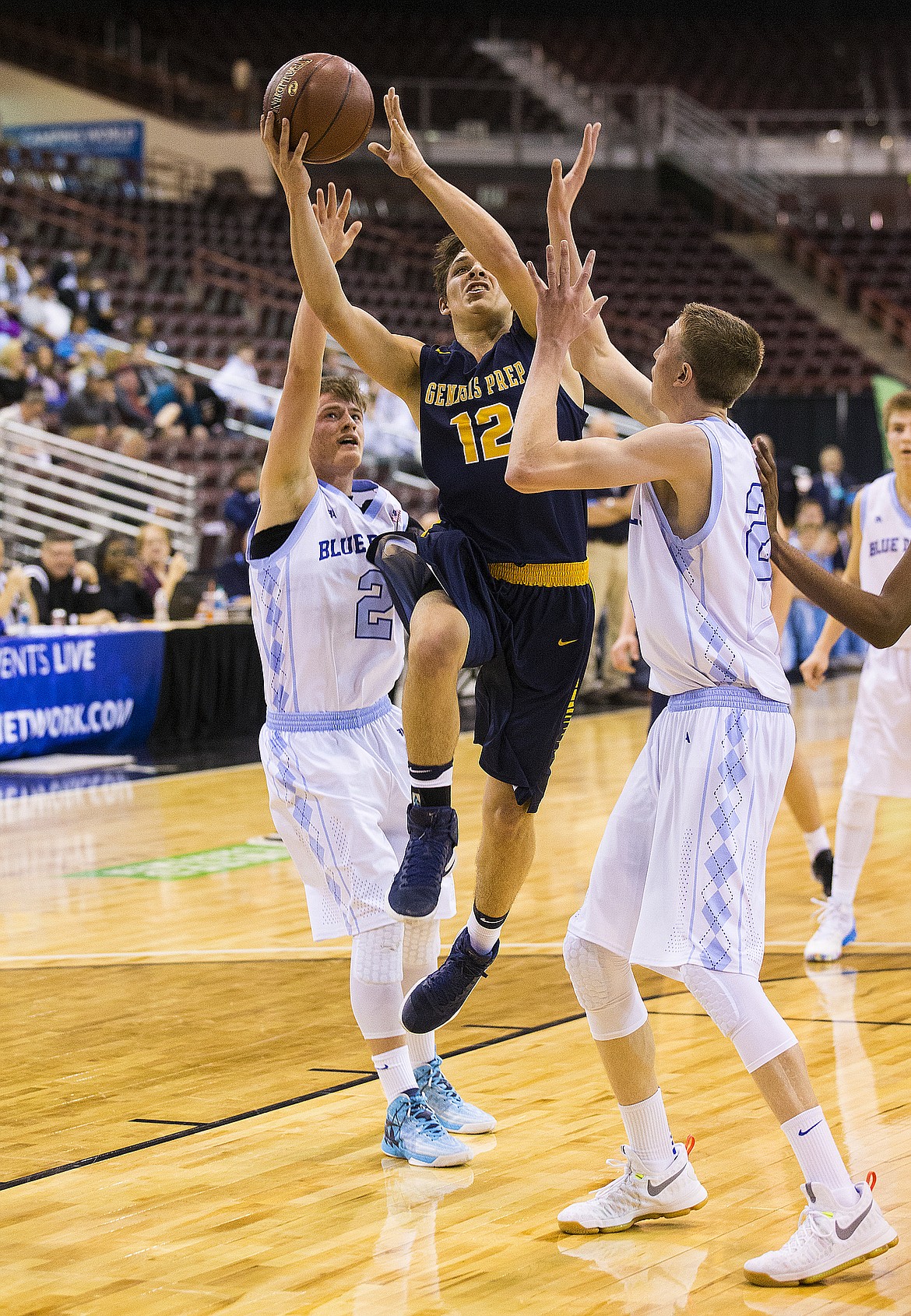 LOREN BENOIT/PressGenesis Prep guard Max Reidt goes for a layup while draped by two Dietrich defenders.