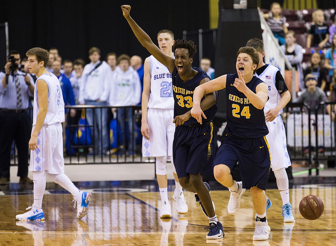 LOREN BENOIT/PressGenesis Prep players Stephane Manzi (33) and Jonny Hillman (24) celebrate their 68-62 win over Dietrich for the 1A DII championship trophy Saturday morning at the Ford Idaho Center