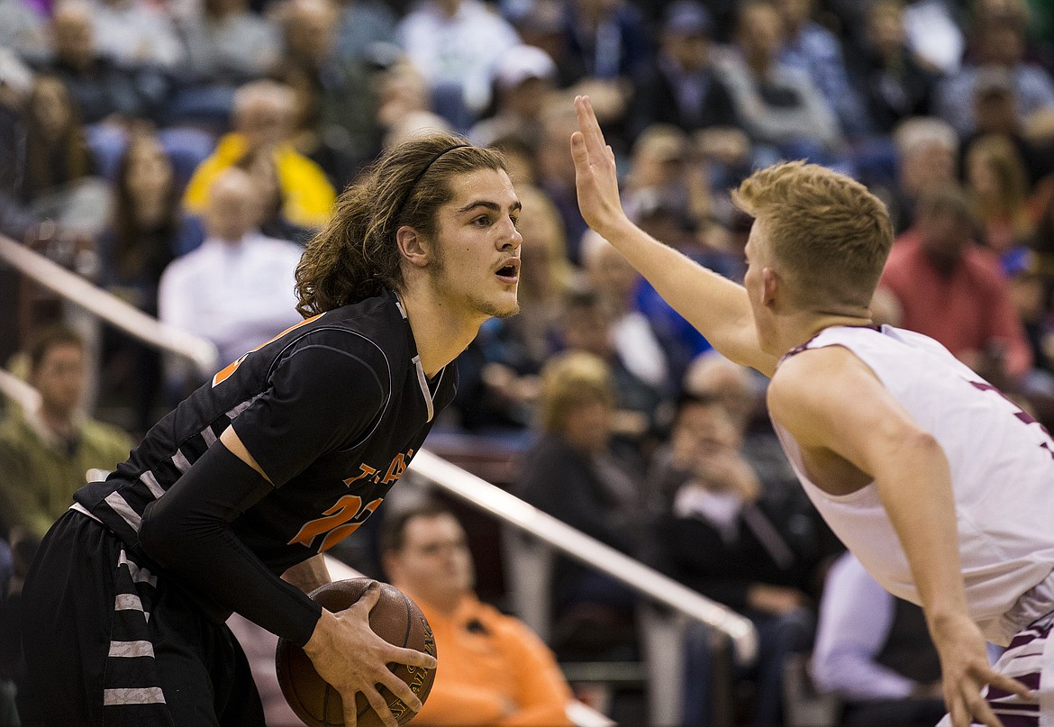 LOREN BENOIT/PressKam Modrow, of Centennial, defends against Post Falls' Jake Pfennigs in the second half of the 5A state tournament semifinal game Friday night at the Ford Idaho Center.