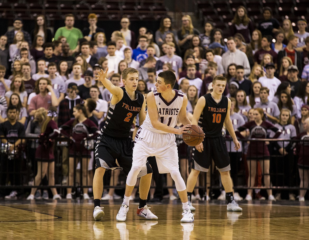 LOREN BENOIT/PressPost Falls' Colby Gennett defends Centennial's Jackson Cleverley in the second half of the 5A state tournament semifinal game Friday night at the Ford Idaho Center.