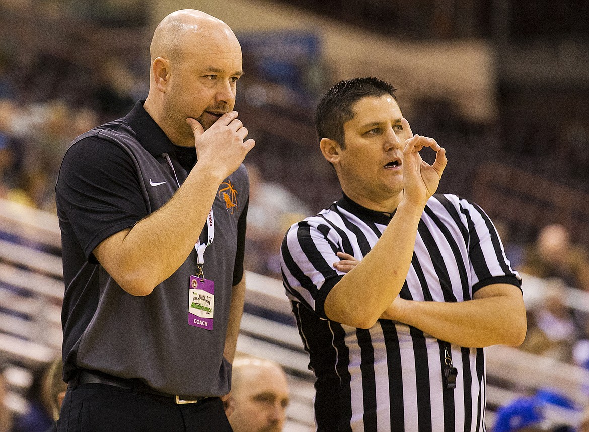 LOREN BENOIT/PressMike McLean talks with an official after a Post Falls foul in the second half of the 5A state tournament semifinal game against Centennial High School Friday night at the Ford Idaho Center.