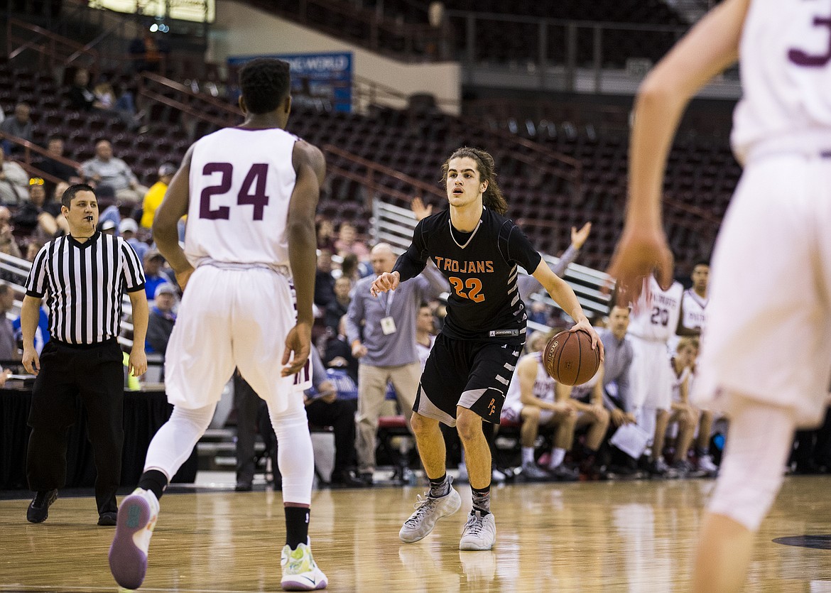 LOREN BENOIT/PressPost Falls' Jake Pfennigs dribbles the basketball as he surveys the Centennial High School defense during the 5A state semifinal game against Centennial High School Friday night at the Ford Idaho Center.