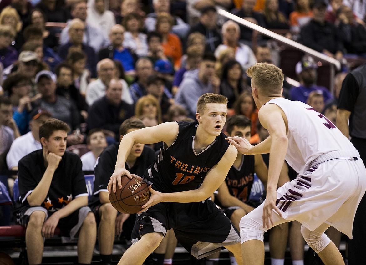 LOREN BENOIT/PressTanner McCliment-Call (10), of Post Falls, dribbles the ball along the arc during the second half of the 5A state semifinal game against Centennial High School Friday night at the Ford Idaho Center.