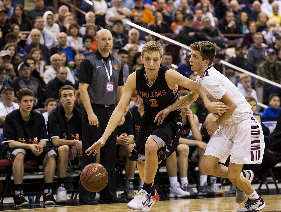 LOREN BENOIT/PressPost Falls' Colby Gennett dribbles the ball by Centennial's Brooks King during the 5A state semifinal game on Friday at the Ford Idaho Center.