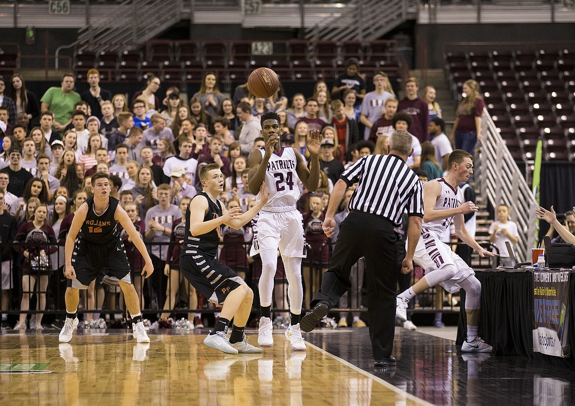 LOREN BENOIT/PressBasketball players from both Post Falls and Centennial High Schools try to keep the basketball inbounds during the first half of the 5A state semifinal game Friday night at the Ford Idaho Center.