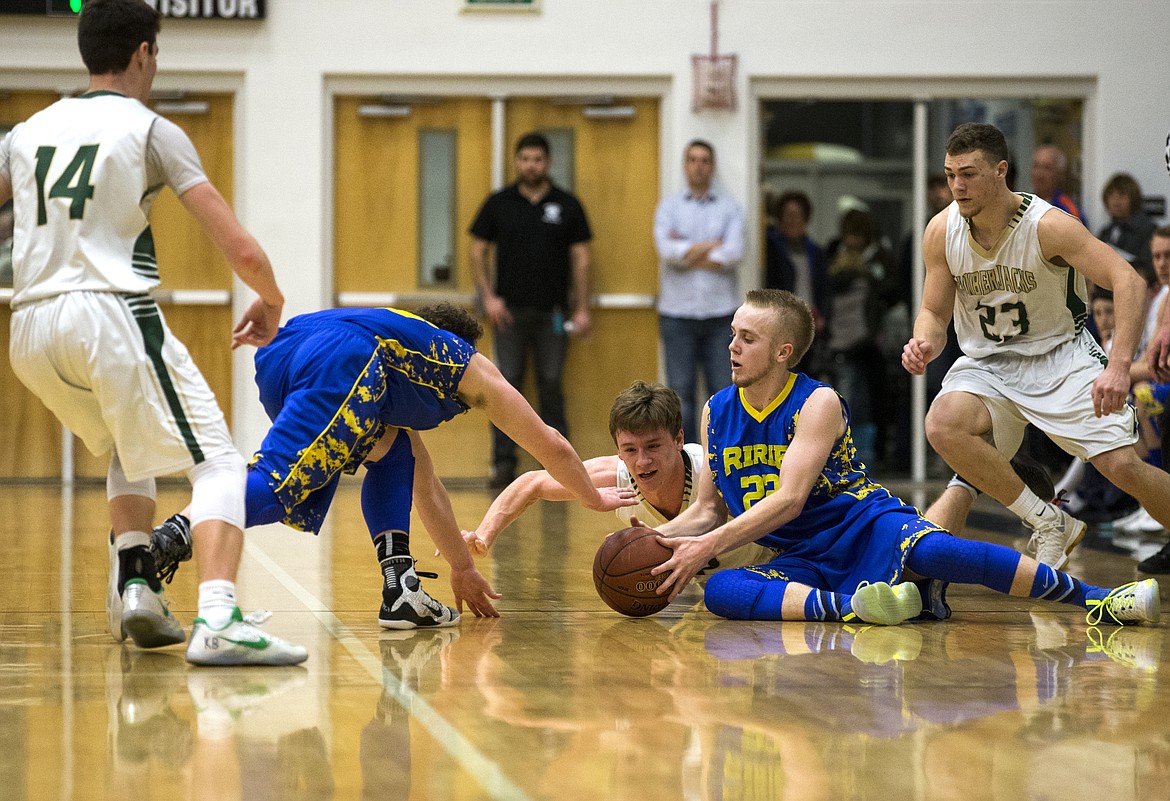 LOREN BENOIT/PressRirie and St. Maries players battle for a loose ball.