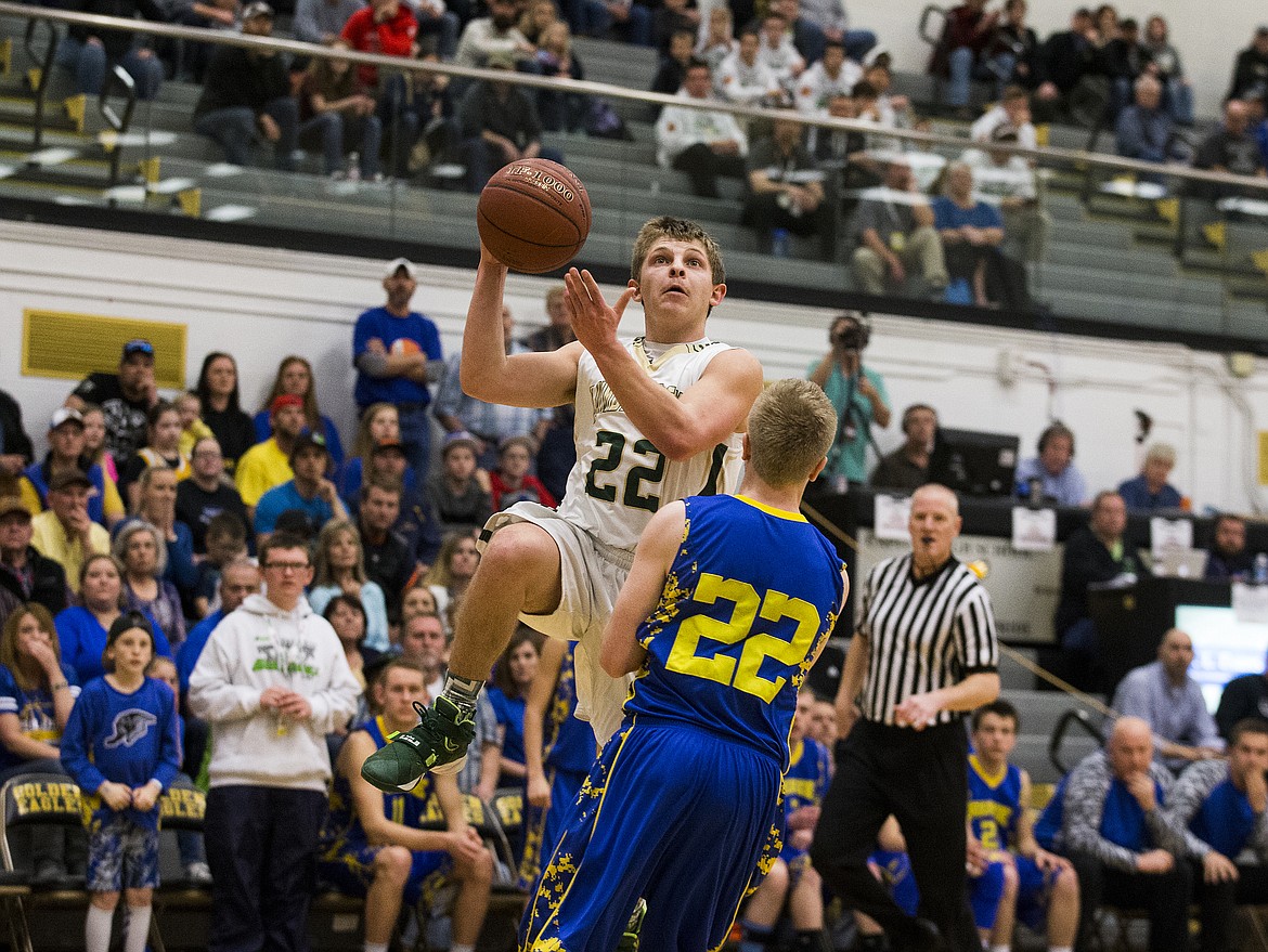 LOREN BENOIT/PressSt. Maries Dakota Wilson (22) drives to the basket against Ririe's Andy Bowden during the 2A state semifinal game at Capital High School. Ririe defeated St. Maries 50-33.