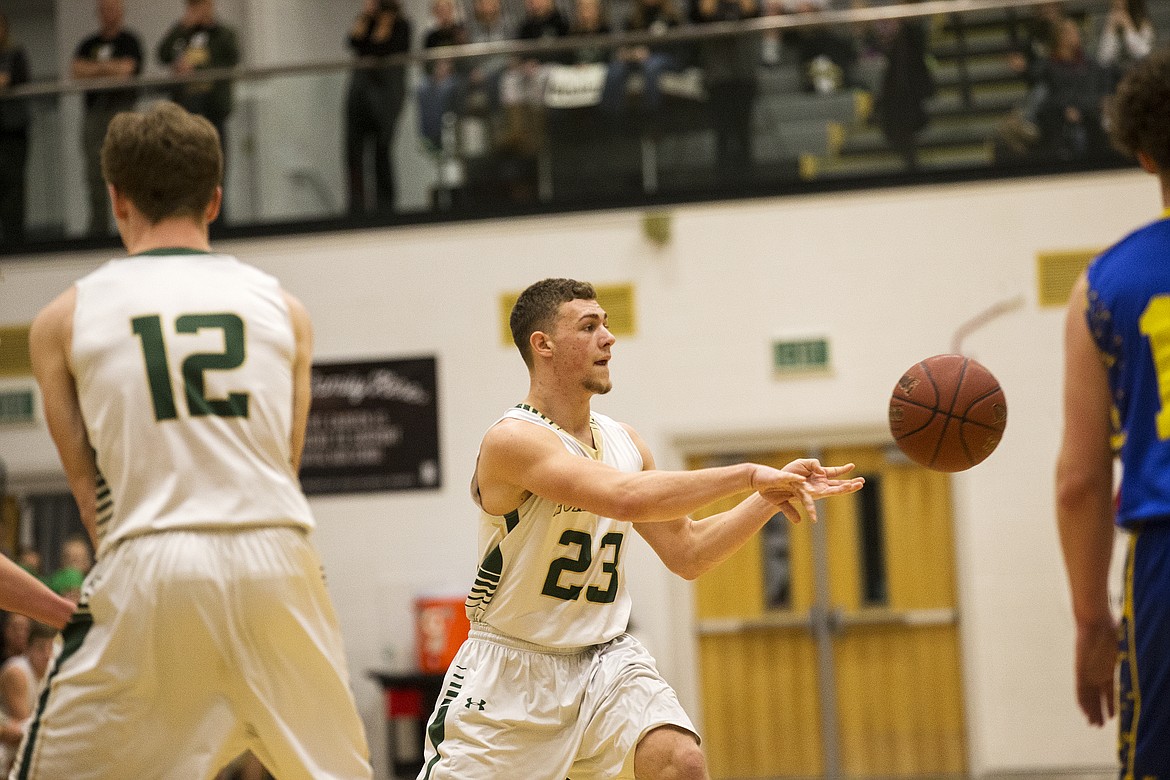 LOREN BENOIT/PressSt. Maries guard Bryant Asbury passes the ball to a teammate during the 2A state semifinal game at Capital High School. Ririe defeated St. Maries 50-33.