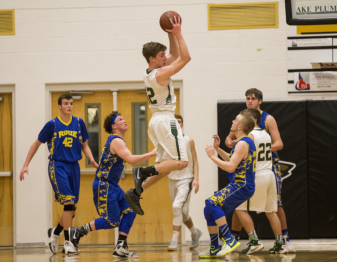 LOREN BENOIT/PressKiefer Gibson, center, of St. Maries, gathers a high pass from a teammate during the 2A state semifinal game at Capital High School. Ririe defeated St. Maries 50-33.