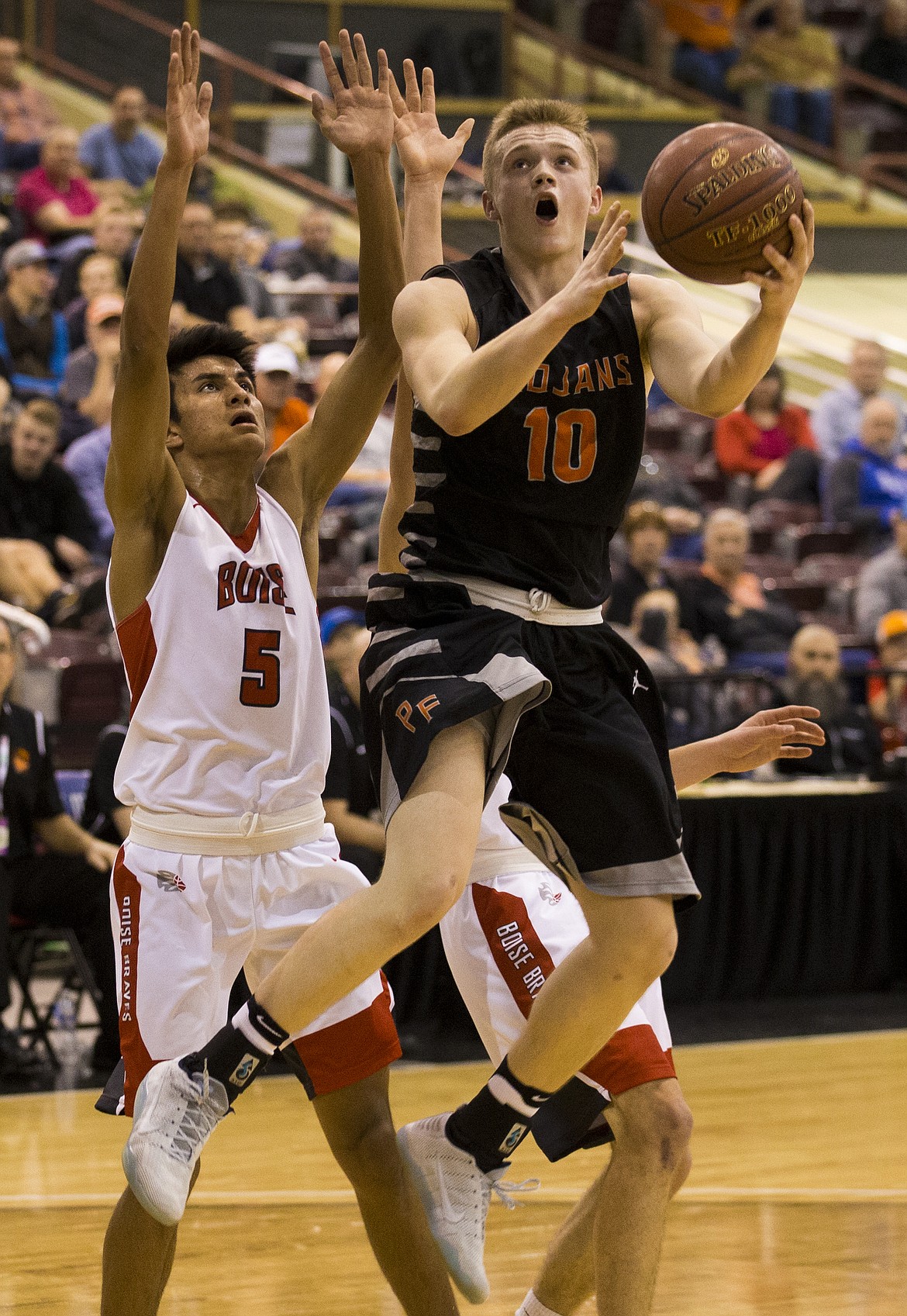 LOREN BENOIT/Press

Post Falls Tanner McCliment-Call goes for a layup against Boises Lucas Centeno during the first half of Thursday nights semifinal game at the Ford Idaho Center in Nampa. McCliment-Call had 15 points in the Trojans 54-52 win.