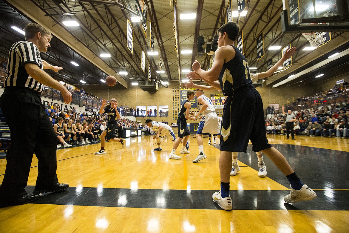 LOREN BENOIT/PressTimberlake High's Jacob James inbounds the basketball to David Dickinson in game 1 of the state 3A boys basketball tournament Thursday at Meridan High School.