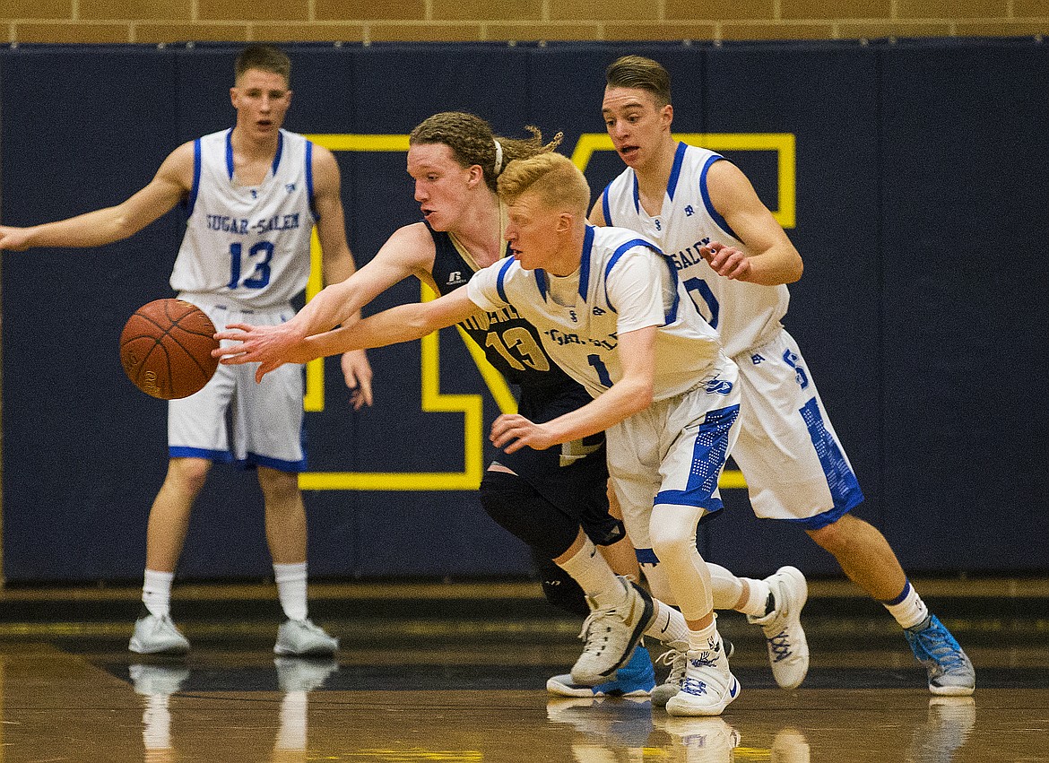 LOREN BENOIT/PressHayden Wood (1), of Sugar-Salem High, applies pressure to Timberlake's Dock Sommers (13) in game 1 of the state 3A boys basketball tournament Thursday at Meridian High School.