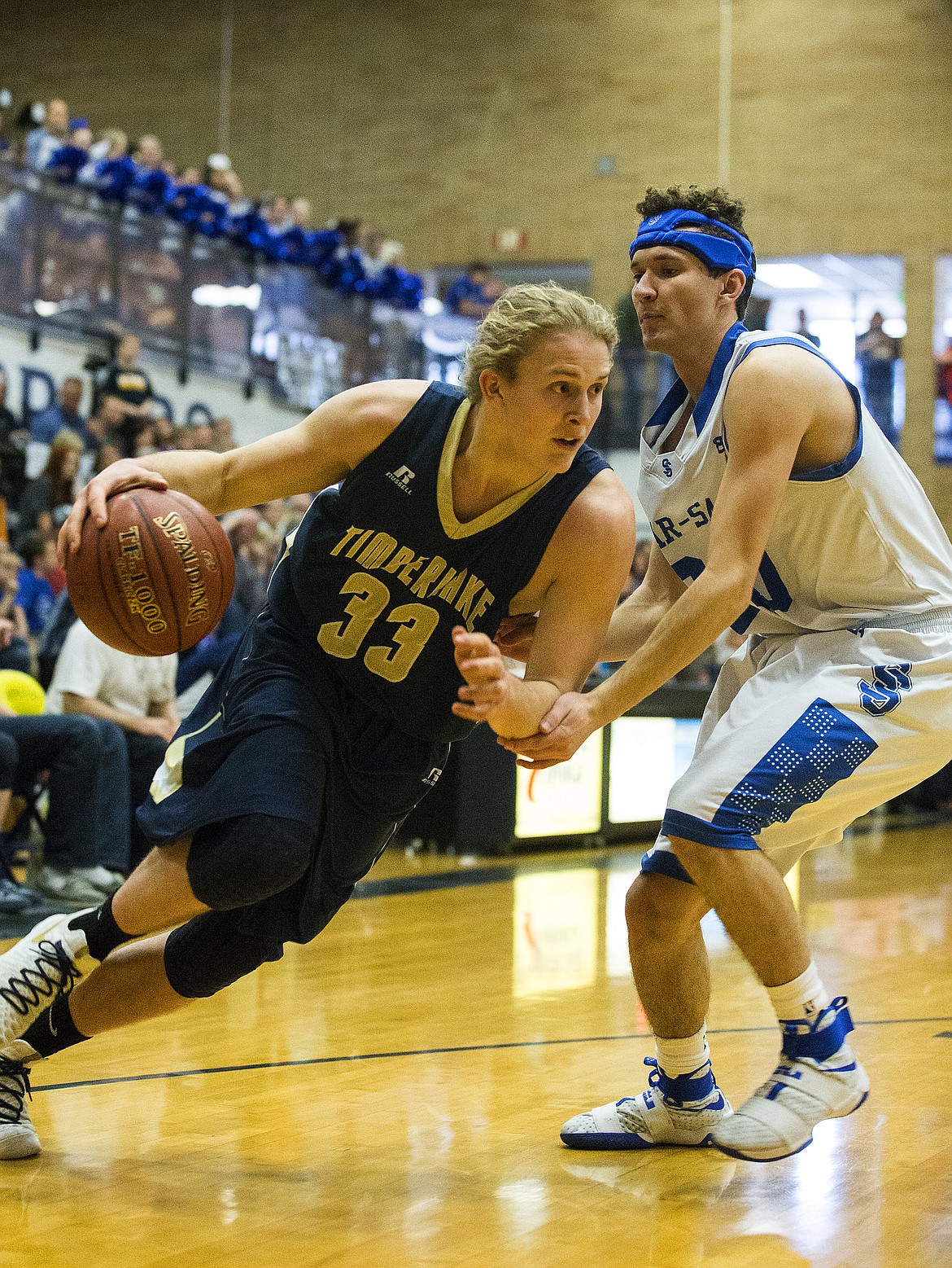 LOREN BENOIT/PressTimberlake senior Brandon Hausladen drives the ball against Sugar-Salem defender Taevin Norman in game 1 of the state 3A boys basketball tournament Thursday at Meridian High School.