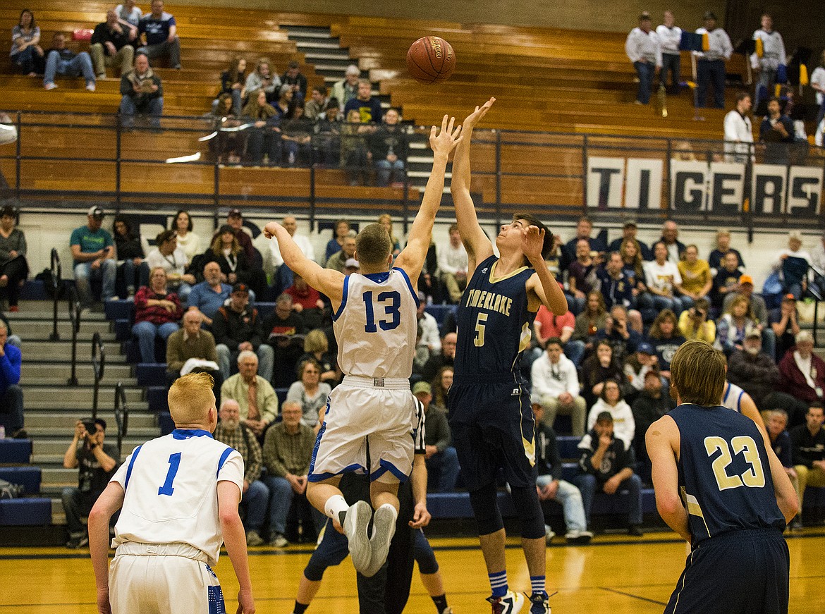 LOREN BENOIT/PressTimberlake's Carter Ostler (5) battles for the opening tip against Sugar-Salem's Parker Miller in game 1 of the state 3A boys basketball tournament Thursday at Meridian High School.