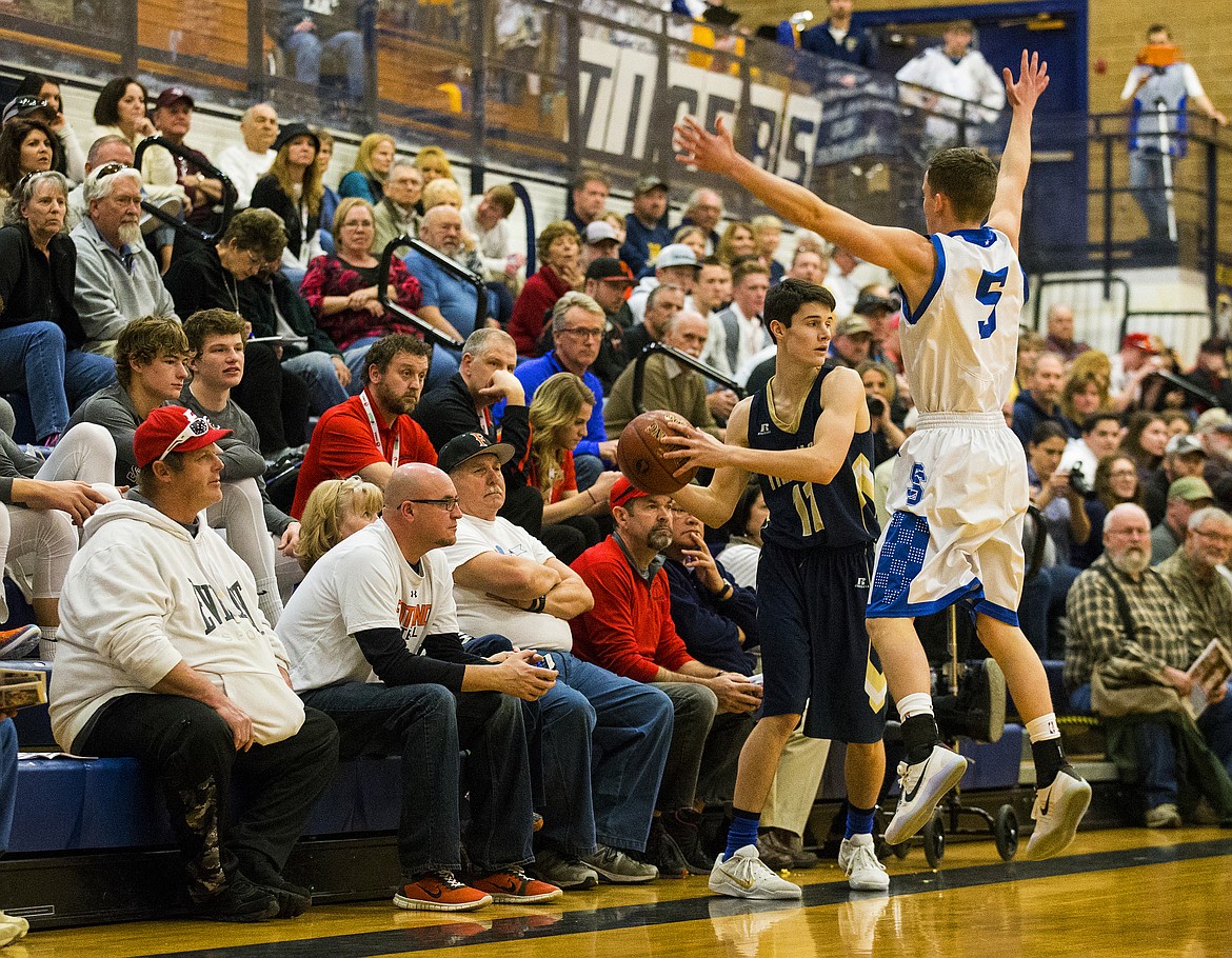 LOREN BENOIT/PressJacob James looks for a teammate as Sugar-Salem's Cameron Gamer tries to disrupt the inbound in the first half of the state 3A boys basketball tournament Thursday at Meridan High School.