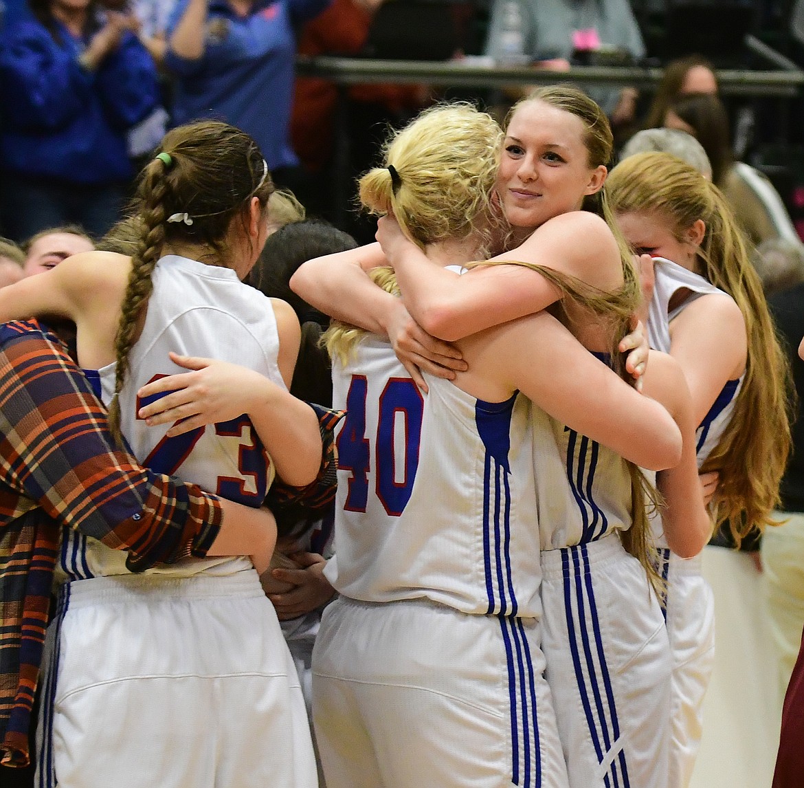 Kiara Burlage hugs teammate Sydney Hovde after the Columbi Falls girls basketball team won the state A championship in Butte Friday. (Chris Peterson photo)