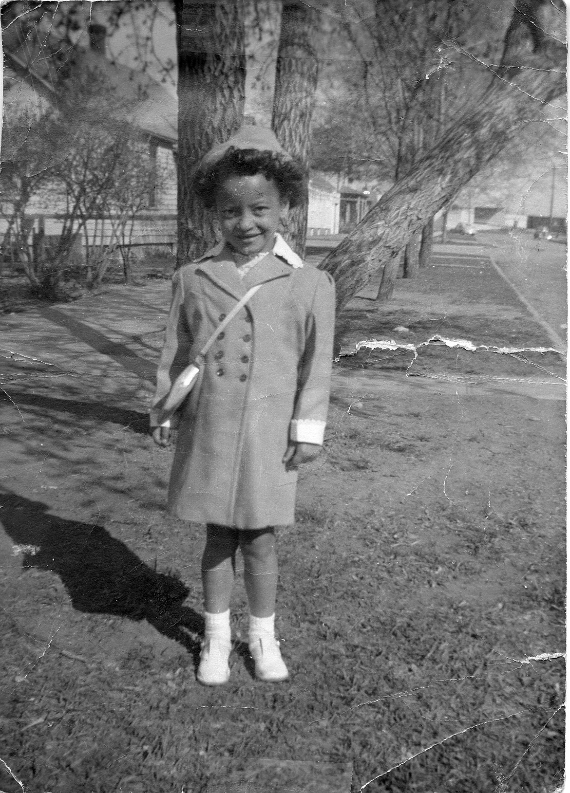 Young Raella moved to Butte when she was 5 years old, but she is pictured here in her hometown of Kalispell outside the family home at Third Avenue West. (Courtesy Willard &#147;Shorty&#148; Stockard)