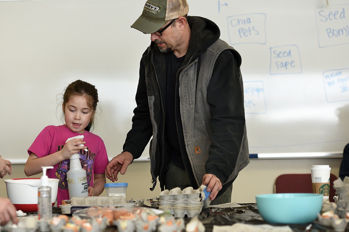 Craig Stevens helps his daughter Isobel Stevens make a chia pet at the Free the Seeds! Seed and Start Fair at Flathead Valley Community College on Saturday. (Aaric Bryan photos/Daily Inter Lake)