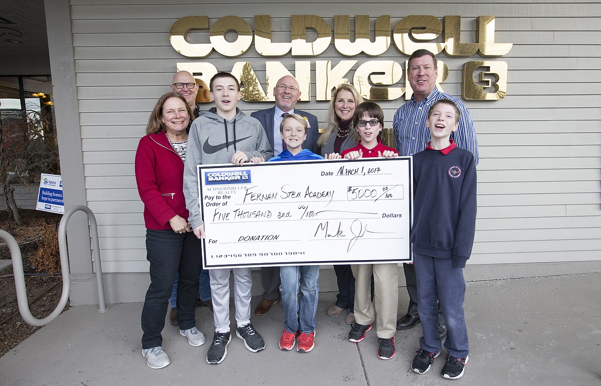 LISA JAMES/PressColdwell Banker of Coeur d'Alene donated $5,000 to Fernan Elemantary School to help build a playground which will be accessible to special needs students. The project was researched by then 5th, now 6th graders pictured, who flushed out what the playground would need to accommodate their special needs classmates. Fernan advanced learning teacher Pamela Kiefer, front left, is pictured with her students from left: Zach Johnson, 12, Kyle Bridge, 12, Paden Parisot, 12, and Cameron Childers, 11. Pictured in the back row, from left: Project manager Chris Shelton, Fernan principal Bill Rutherford, life skills teacher Susie Brott and Coldwell Banker President Mark Johnson.