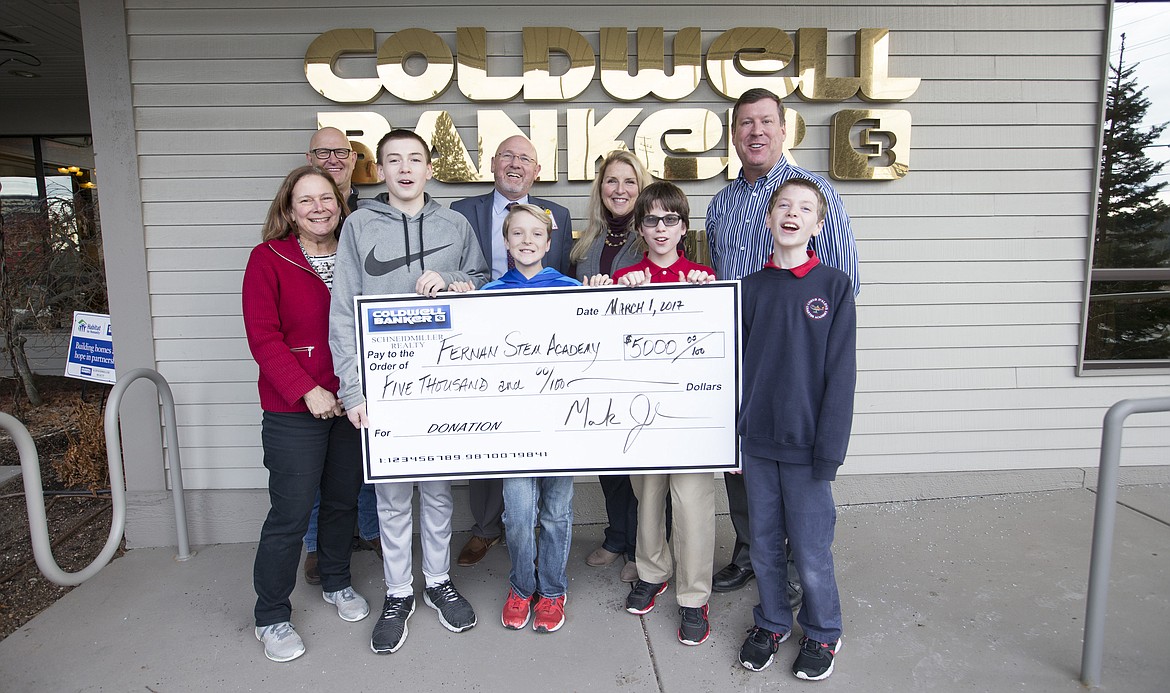 LISA JAMES/Press
Coldwell Banker of Coeur d&#146;Alene donated $5,000 to Fernan STEM Academy to help build a playground which will be accessible to special needs students. The project was researched by then fifth-, now sixth-graders pictured, who fleshed out what the playground would need to accommodate their special-needs classmates. Pictured from left, front row: Fernan advanced learning teacher Pamela Kiefer, front left, is pictured with her students from left: Zach Johnson, 12, Kyle Bridge, 12, Paden Parisot, 12, and Cameron Childers, 11. Pictured in the back row, from left: Project manager Chris Shelton, Fernan principal Bill Rutherford, life skills teacher Susie Brott and Coldwell Banker president and CEO Mark Johnson.