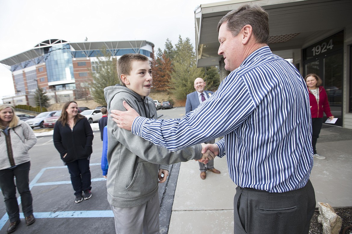 LISA JAMES/PressFernan 6th grader Zach Johnson, 12, thanks Coldwell Banker President Mark Johnson on Wednesday for the donation which will help the school build a playground to accommodate their special needs students.Caldwell Banker of Coeur d'Alene donated $5,000 to Fernan Elemantary School to help build a playground which will be accessible to special needs students. The project was researched by Zach and a team of three of his other classmates.