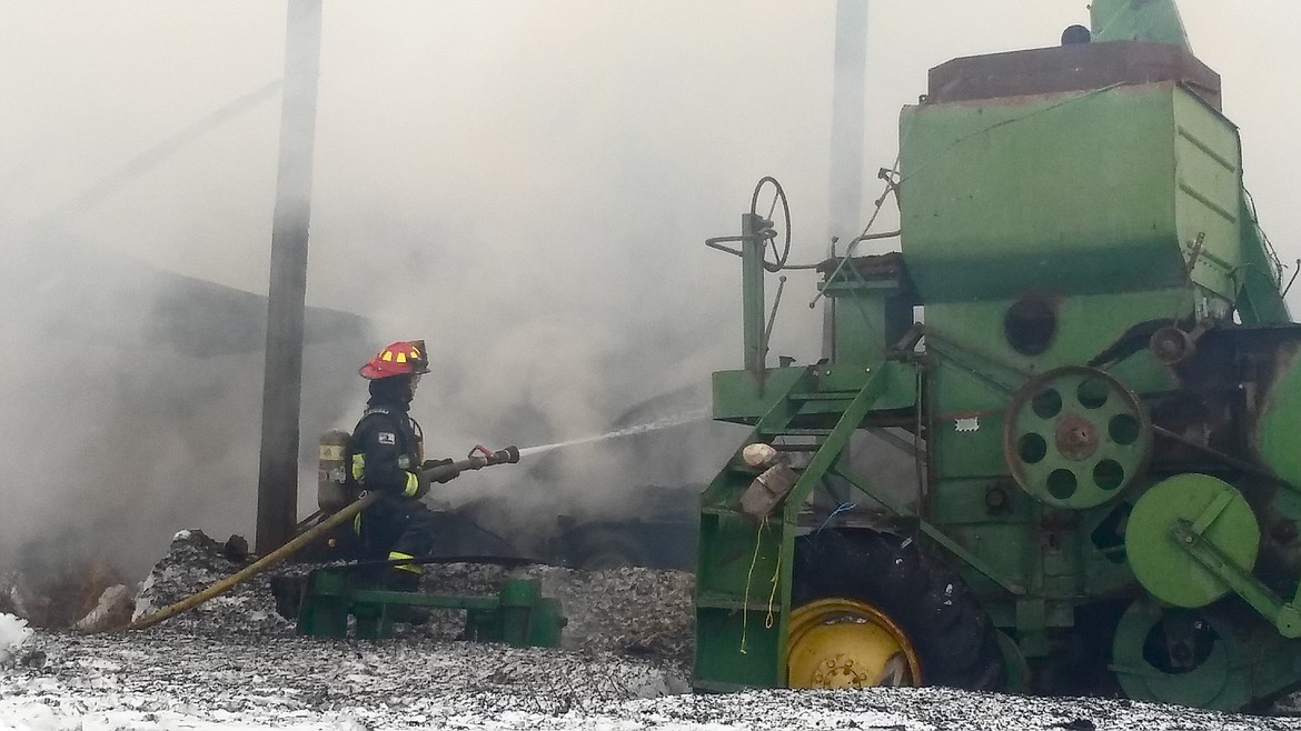 &#151;Photo by JASMINE GEORGE
North Bench firefighter Colin Mangus on the scene of the Echo Drive structure fire on Monday.