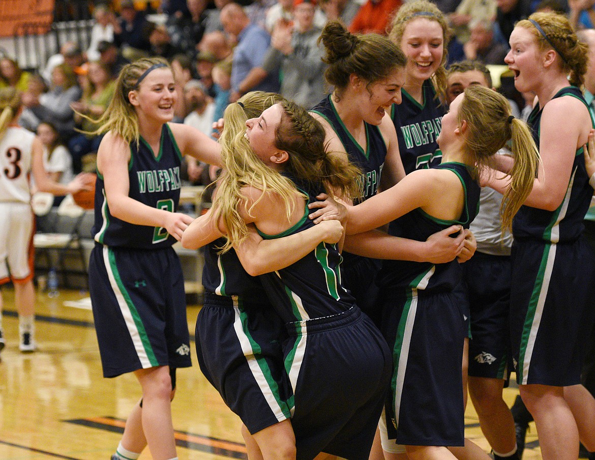 The Glacier Wolfpack celebrate after beating the Flathead Bravettes 51-42 at Flathead Thursday to advance to the state tourney. (Aaric Bryan/Daily Inter Lake)