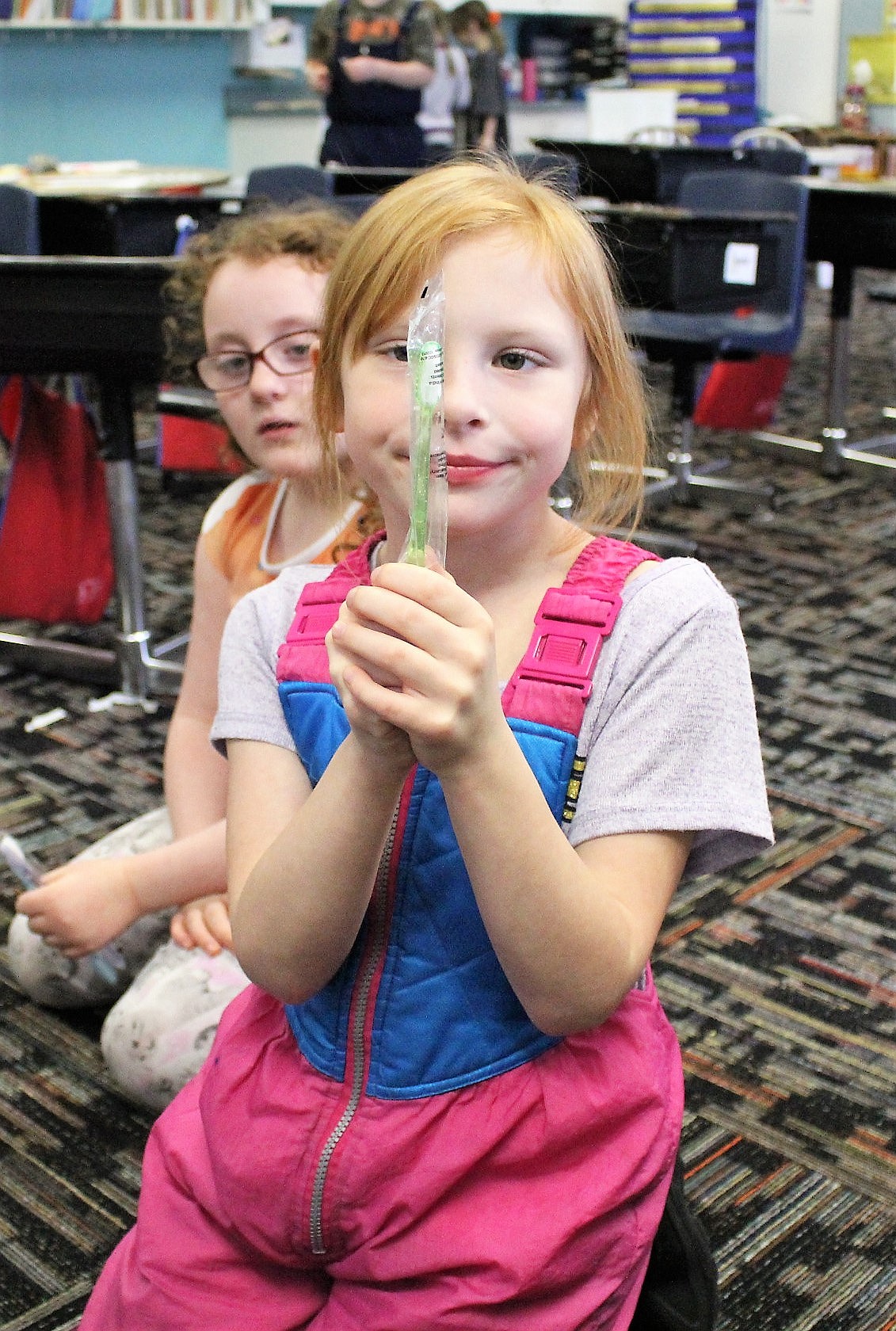 Kendra, a first-grader at Superior Elementary School, holds up her new toothbrush. School nurse, Barb Jasper spoke with the class about proper dental hygiene as part of Oral Health Month in February. (Kathleen Woodford/Mineral Independent).