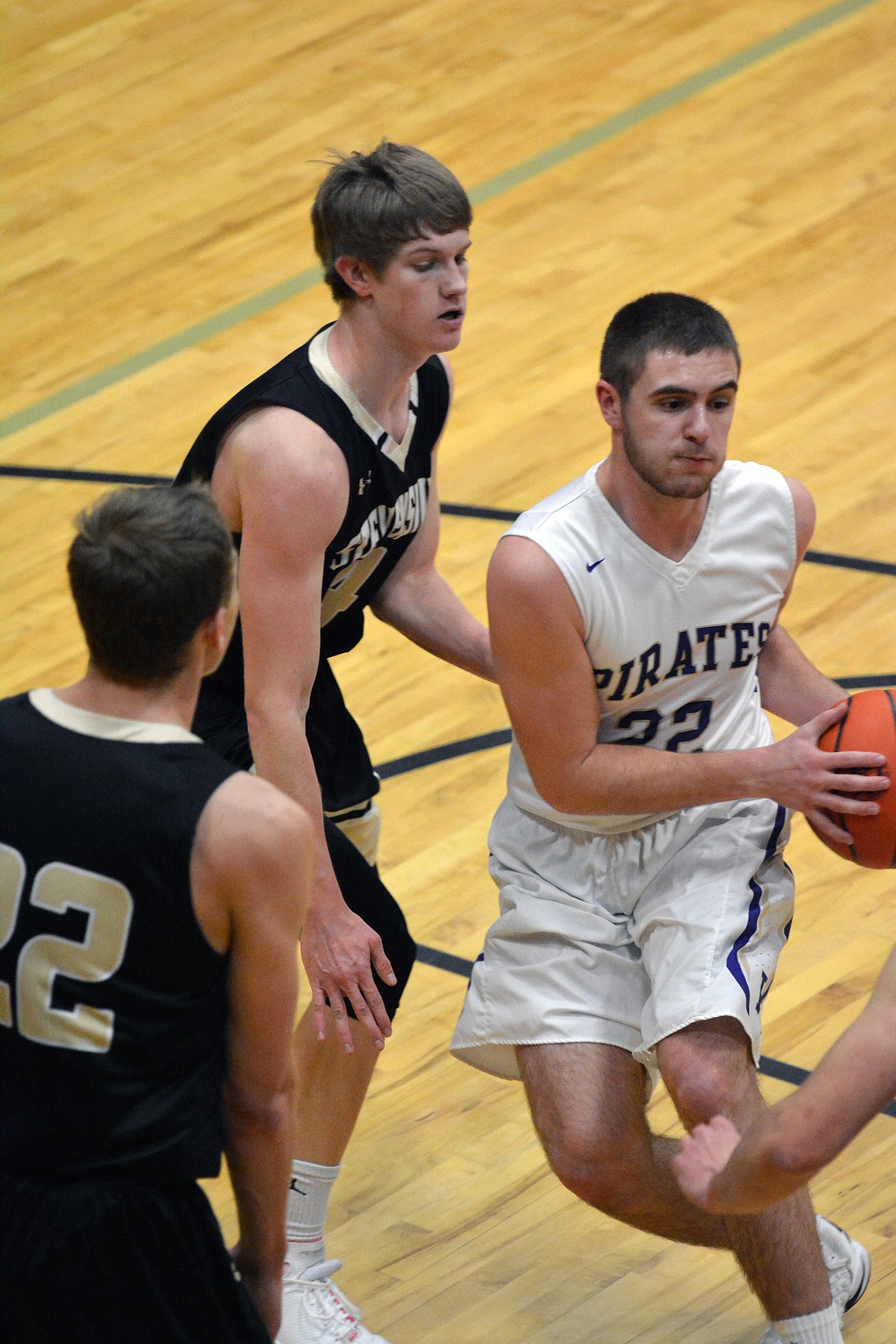 POLSON PIRATE GUARD Tanner Wilson looks for the open man in a regular-season game against Stevensville at Linderman Elementary. According to Coach Randy Kelley, Wilson is a key to the Pirates defensive scheme as they prepare to play Billings Central in the first round of the Class-A Montana State basketball tournament Thursday at the Butte Civic Center. (Jason Blasco/Lake County Leader)