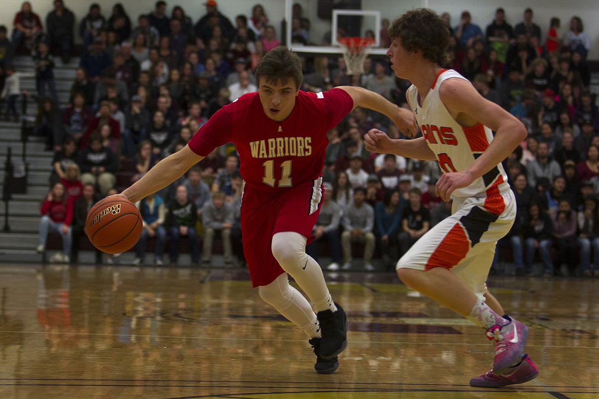 ARLEE GUARD Tyler Tanner drives the lane in the Class-C Western Divisional playoff game against Hot Springs (Jeremy Weber/Lake County Leader)