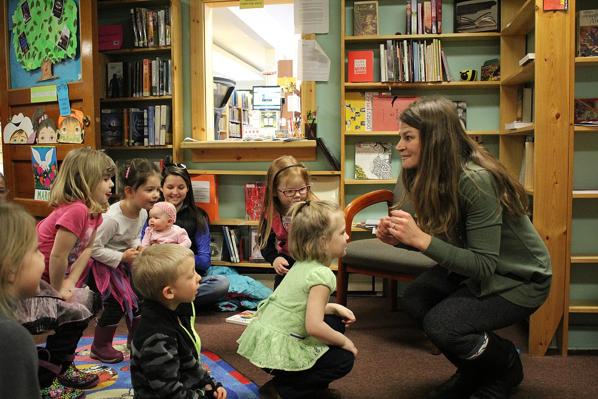 Laura Acker, from Parents as Teachers, gets the kids moving during an event at the Mineral County Library celebrating the birthday of Dr. Seuss. (Kathleen Woodford/Mineral Independent)