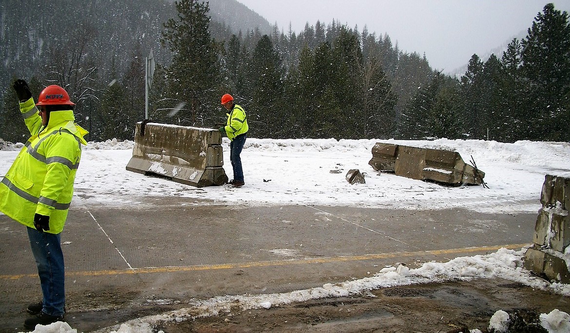 Highway workers try to divert traffic away from several cement barriers which were pushed into the eastbound lane on I-90 during a March 1 accident.