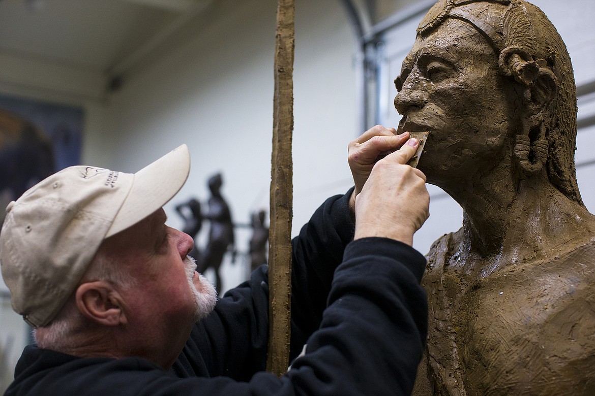 LOREN BENOIT/PressTerry Lee applies the final touches to a 6-foot-6-inch tall Maasai warrior sculpture inside his Hayden studio on Feb. 16, 2017.