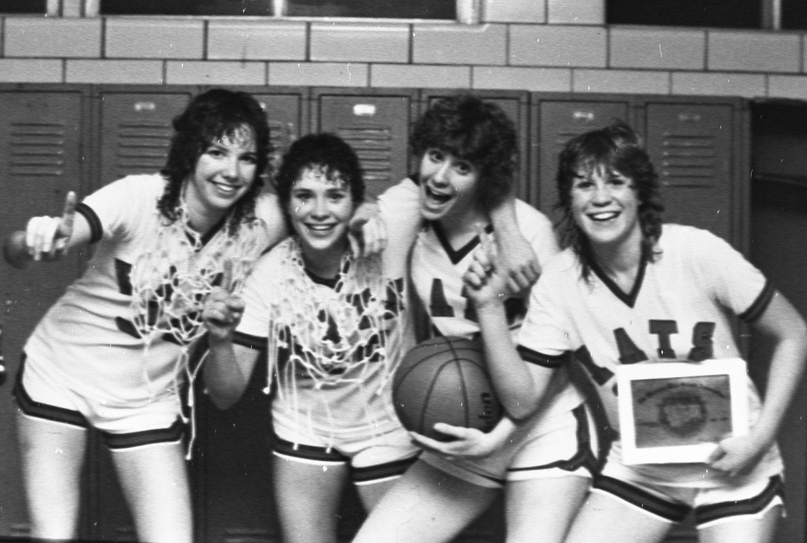 Wildkat seniors whoop it up in the locker room after winning the state championship in 1983. From left is Becky Countryman, Robin Allen, Debby Downen and Kendy Bell.