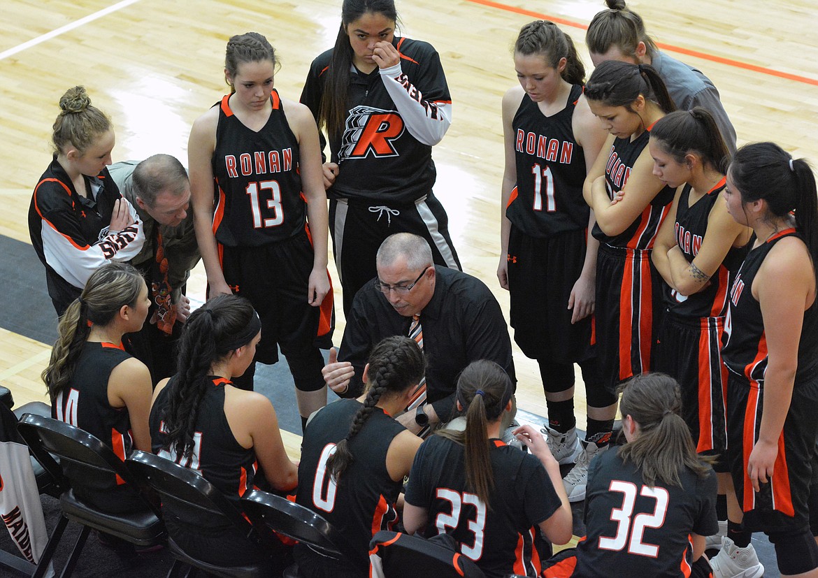 RONAN HIGH School Coach Ron Hanson discusses strategy with his team during a timeout in the Western-C Divisional Championship game against Florence Saturday at the Ronan Events Center. (Jason Blasco/Lake County Leader)