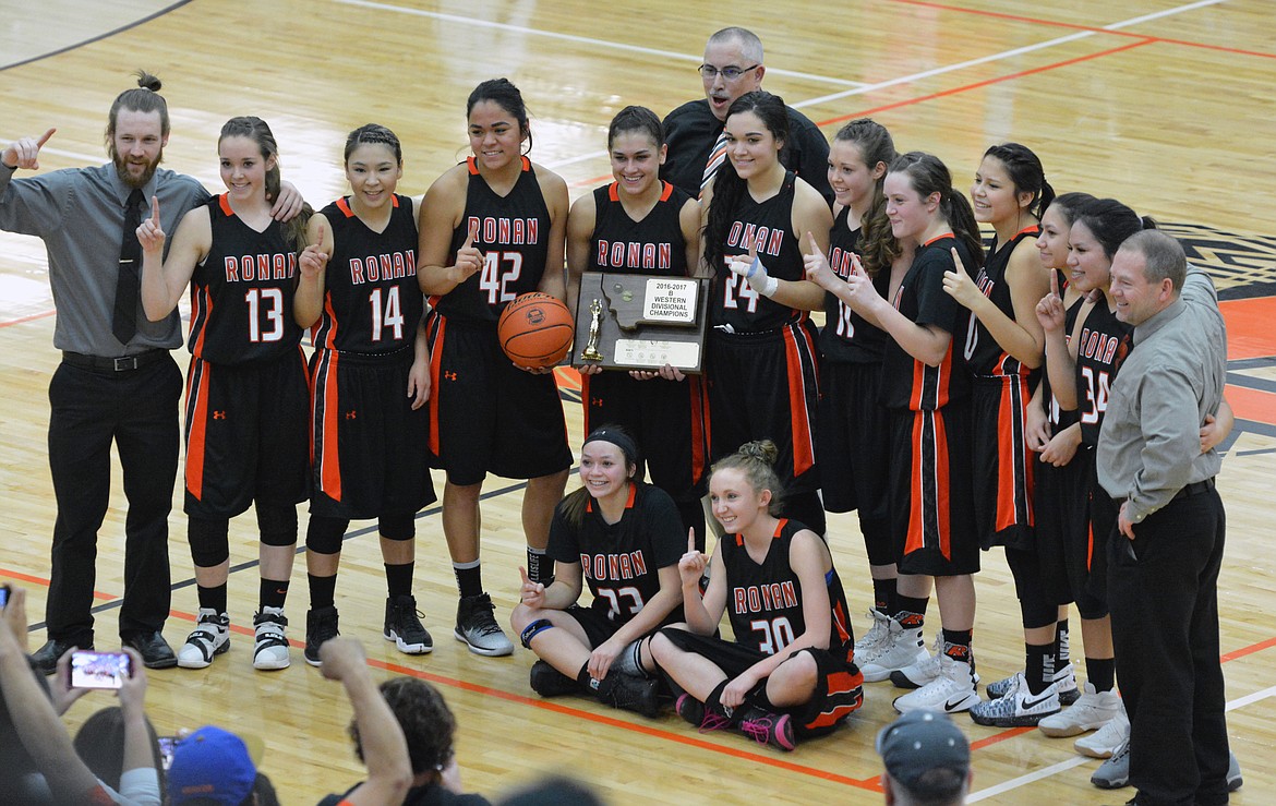 THE RONAN Maidens hoist the trophy after their 64-55 victory over Florence at the Western Class-C Divisional Championship Saturday night at the Ronan Events Center. (Jason Blasco/Lake County Leader)