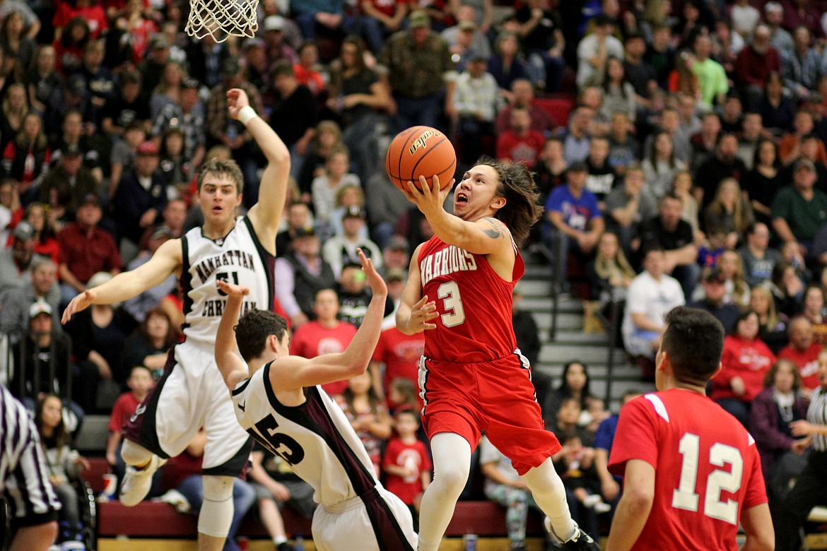 Arlee&#146;s Will Mesteth goes in for a tough layup against Manhattan Christian Saturday. (Kathleen Woodford/Lake County Leader)