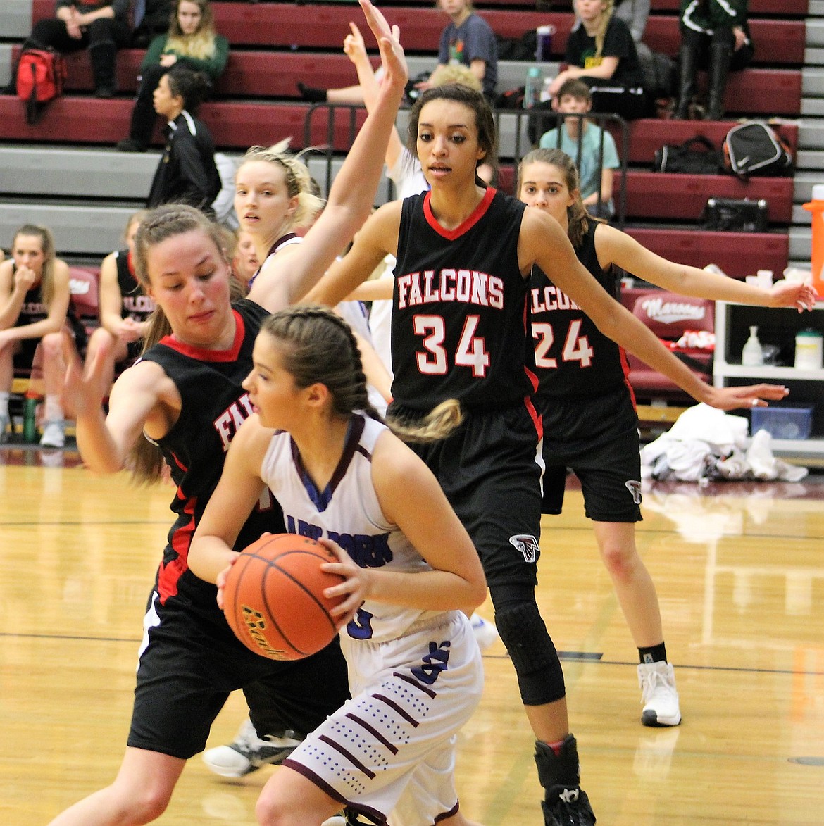 Mountain Cat, Kenzie Mueller tries to get past Falcon player during Thursday&#146;s game in Butte, Cats lost 44-22. The Twin Bridges Falcons won divisionals championship in a game against Arlee on Saturday. (Kathleen Woodford/Mineral Independent).