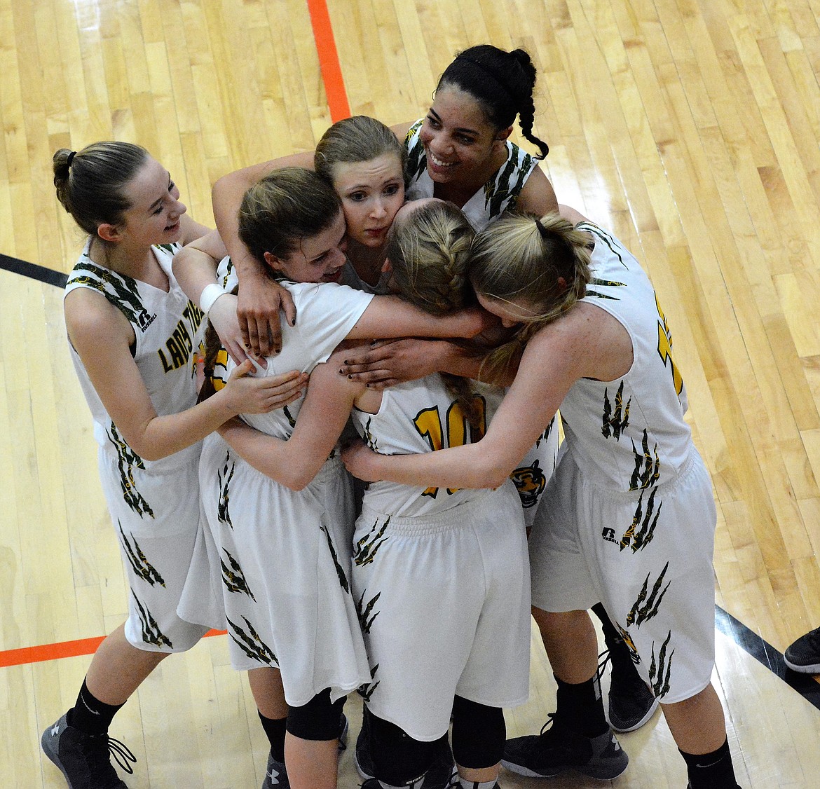 The St. Regis girls team celebrates after their 42-37 victory over Charlo in the Class-C District Challenge game Monday night at the Ronan Events Center. (Jason Blasco)