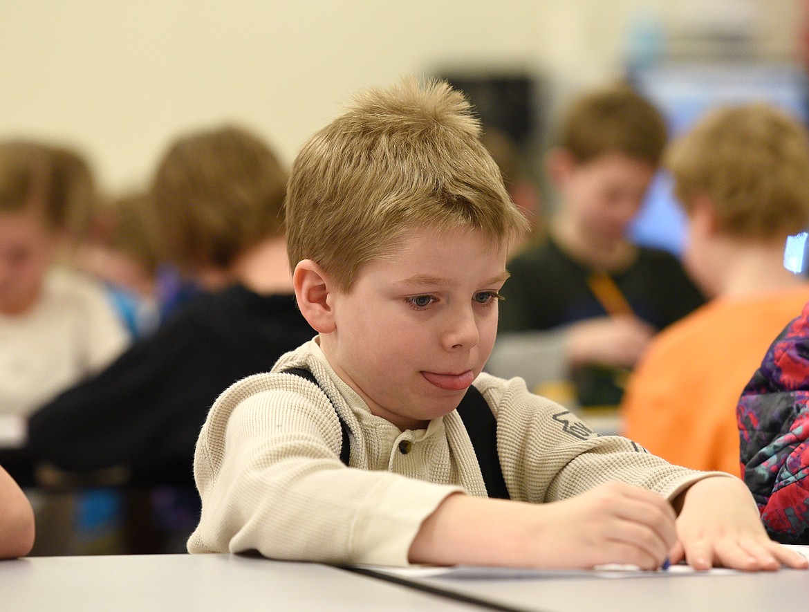 Creston third-grader Alucard Armes works on his ledger art project during a visit from the Art Mobile of Montana at the school on Tuesday. (Aaric Bryan/Daily Inter Lake)