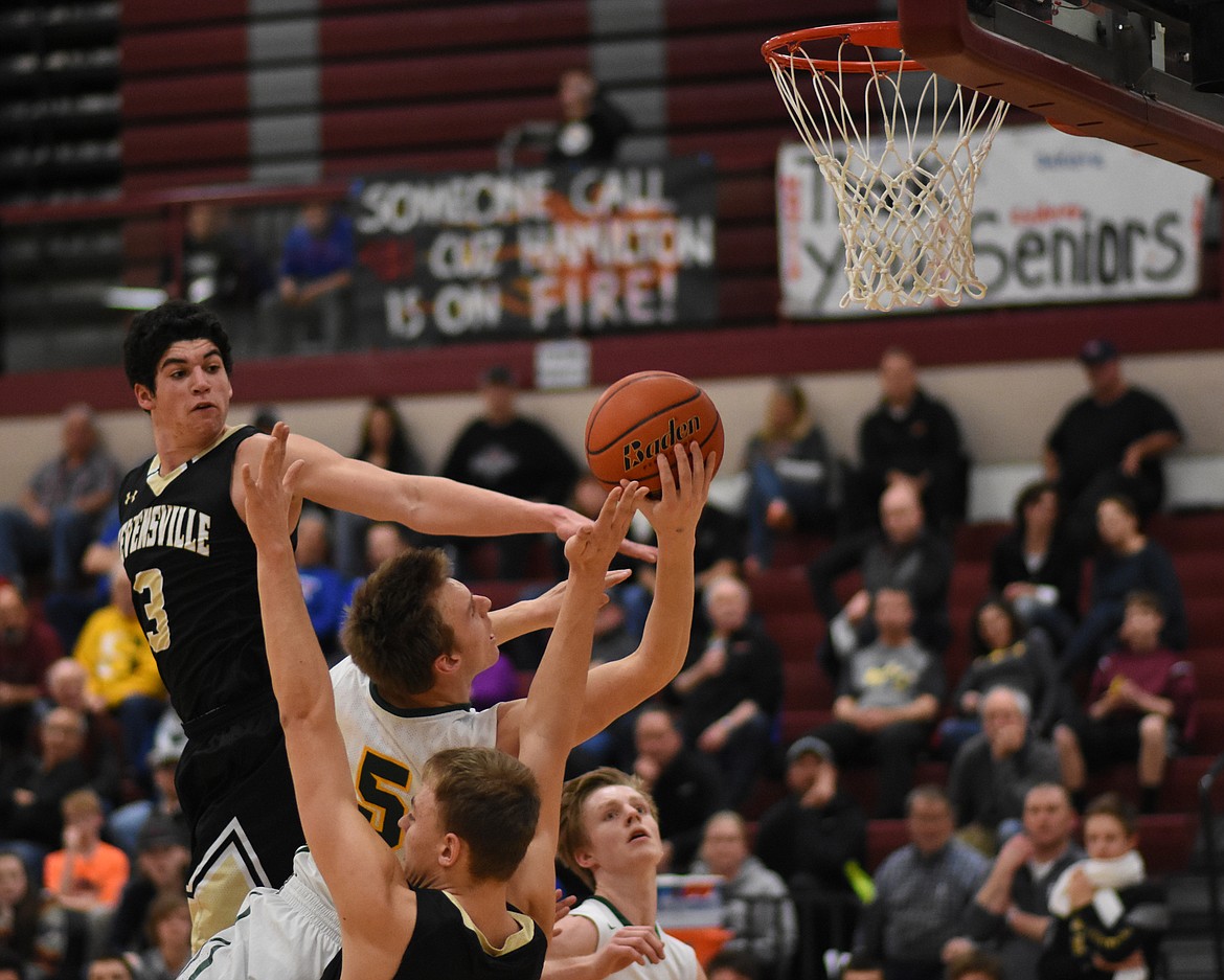 Derek Kastella fights through contact against Stevensville at the Western A Divisional Tournament in Hamilton.