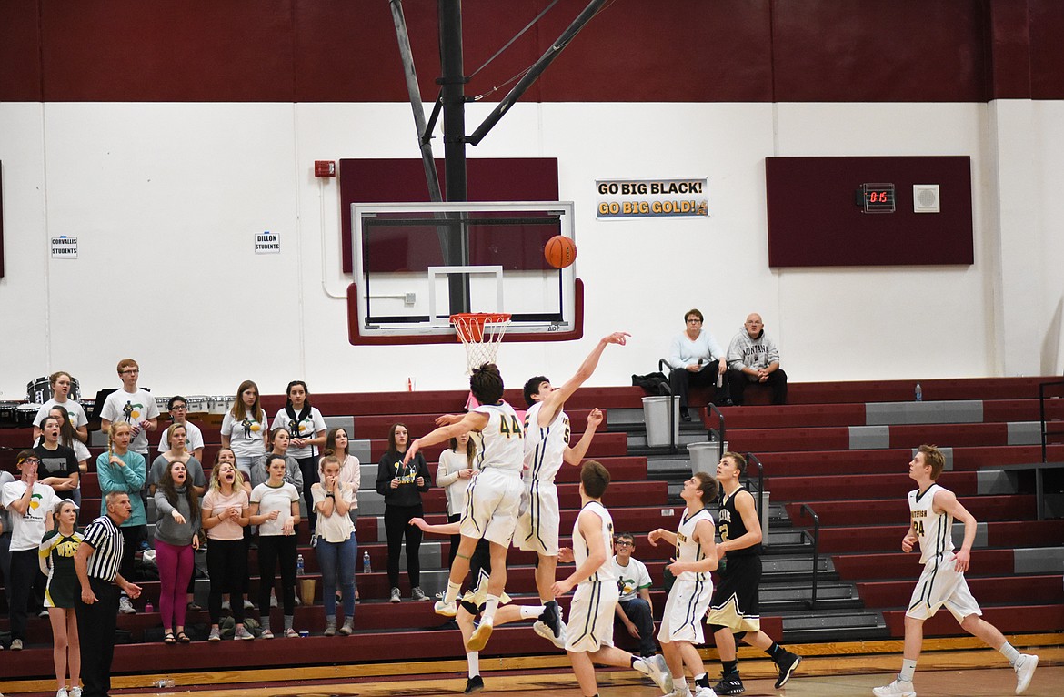 Dillon Botner blocks a Stevensville shot attempt at the Western A Divisional Tournament in Hamilton.